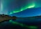 Aurora borealis in Iceland above a lake with boat