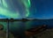 Aurora borealis in Iceland above a lake with boat