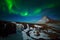 Aurora Borealis from Iceland. Beautiful green Northern Lights on the dark blue night sky with peak with snow, Kirkjufell, Iceland.