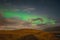 Aurora Borealis in Iceland northern lights bright beams over hiking path