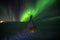 Aurora borealis lights at night in white snow tundra, Russia, North. Beautiful arctic polar landscape of green lightning lines,