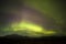 Aurora borealis with lonely mountain on Iceland.