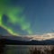 Aurora borealis moon-lit clouds over Lake Laberge