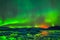 Aurora borealis in night northern sky. Ionization of air particles in the upper atmosphere