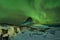 Aurora Borealis the Northern Light at Kirkjufell Iceland. scenic view of waterfall Kirkjufellsfoss aurora polaris in background.