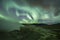 Aurora Borealis (Northern Lights) above geothermal volcanic vents in Hveravellir