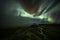 Aurora Borealis (Northern Lights) above geothermal volcanic vents in Hveravellir