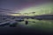 Aurora Borealis Northern Lights above Jokulsarlon Glacier Lagoon with photographer