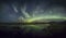 Aurora Borealis (Northern Lights) above a lake with reeds and grass