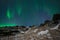 Aurora Borealis or Northern Lights above the mountains, Iceland