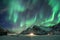 Aurora Borealis, Northern Lights over snow mountain and traveler walking on winter at Lofoten Islands