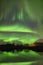 Aurora borealis, northern lights. Scenic fjord on Lofoten islands, Reine, Norway.