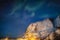 Aurora borealis over snow mountain in Reine town at Lofoten Islands