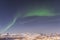 Aurora borealis over Tromso seen from Floya hill