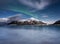 Aurora Borealis. Skagsanden beach on Lofoten Islands, Norway.. Stars and northern light. Reflections on the water surface.