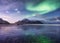 Aurora Borealis. Skagsanden beach on Lofoten Islands, Norway. Stars and northern light. Reflections on the water surface.