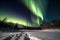 Aurora borealis snow foreground and distant hills. Northern lights.