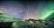 Aurora borealis with starry over mountain range on arctic coastline