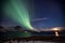 Aurora Borealis in Tromso, Norway in front of Norwegian fjord at winter