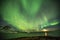 Aurora Borealis in Tromso, Norway in front of Norwegian fjord at winter