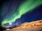 Aurora Borealis in Tromso, Norway in front of Norwegian fjord at winter