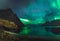 Aurora over sandy beach haukland, Kvalvika and Skagsanden with stones in Norway, Lofoten islands. Northern lights in