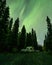 Aurora shining over Camping Caravan in Swedish forest Tannforsen Waterfall Northern Lights color sky Sweden, Scandinavia