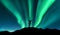 Aurora and silhouette of standing woman with raised up arms on the mountain in Norway. Aurora borealis