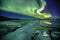 Auroral over the glacier lagoon Jokulsarlon in Iceland.