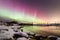 Auroras at wintry riverbank