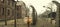 AUSCHWITZ, POLAND - March 30 2012 Melancholic view through a wired electric fence of a concentration camp. Sign reads