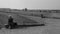 AUSCHWITZ, POLAND - March 30 2012: Visitor lady taking a picture of the remains of barracks in Birkenau