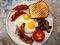 Aussie / Australian Breakfast with Brioche Toast, Fried Eggs, Crispy Bacon Sausage and Mushrooms