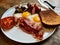 Aussie / Australian Breakfast with Brioche Toast, Fried Eggs, Crispy Bacon Sausage, Salty Pancakes and Mushrooms