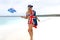 Aussie girl waving Australian flag on stunning pristine beach