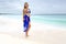 Aussie woman on beach wearing bikini and sarong