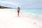 Aussie woman playing frisbee on the beach