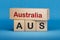 Australia and AUS symbol. Concept words Australia and AUS on wooden blocks.