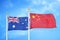 Australia and China two flags on flagpoles and blue cloudy sky