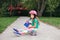 Australia Day card with text. Caucasian girl in helmet on skateboard waving Australian flag. Smiling sporty young child sitting on