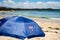 Australia Day concept background: patriotic Aussie umbrella featuring Australian flag on the beautiful sandy beach