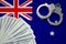 Australia flag with handcuffs and a bundle of dollars. The concept of illegal banking operations in US currency