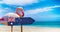 Australia flag on wooden table sign on beach background with pink flamingo. There is beach and clear water of sea and blue sky in