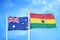 Australia and Ghana two flags on flagpoles and blue cloudy sky