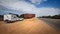 Australia`s longest straight road sign with caravan and vehicle