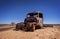 Australia â€“ Outback desert with an old vintage abandoned car near the track