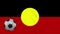 Australian Aboriginal - Mariya flag and soccer ball rotates on background of waving cloth, loop