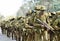 Australian army soldiers marching road to base in camouflage bush war tactics training