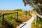 Australian Beach with grassy sand dune and walkway to sea