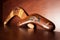 Australian boomerangs seen from the side, lying on the vintage brown shelf. Souvenirs from Australia on display in the living room